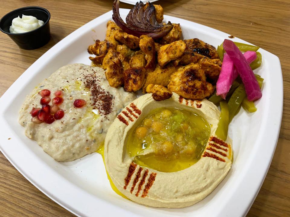 The chicken tawook platter at Scottsdale's De Babel, with hummus and baba ghanoush.