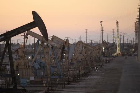 Oil rig pumpjacks, also known as thirsty birds, extract crude from the Wilmington Field oil deposits area where Tidelands Oil Production Company operates near Long Beach, California July 30, 2013. REUTERS/David McNew