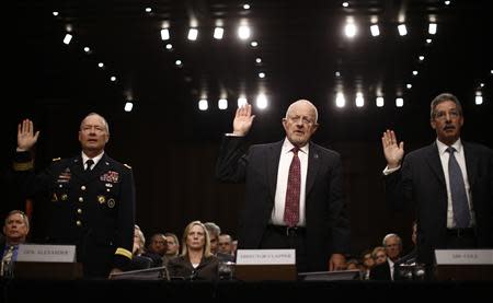 U.S. National Security Agency Director General Keith Alexander (L), Director of National Intelligence James Clapper and Deputy Attorney General James Cole (R) are sworn in to testify at a Senate Intelligence Committee hearing the Foreign Intelligence Surveillance Act legislation on Capitol Hill in Washington, September 26, 2013. REUTERS/Jason Reed (UNITED STATES - Tags: POLITICS)