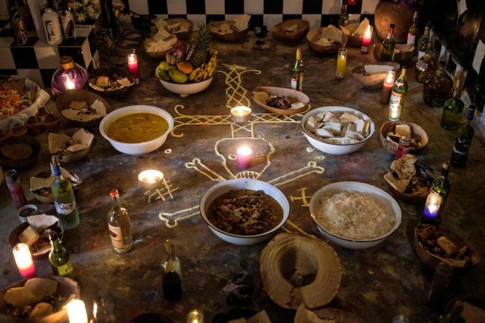 Food, liquor and money sit on an altar during a Vodou ceremony in the Petionville neighborhood of Port-au-Prince, Haiti, Monday, Nov. 1, 2021.