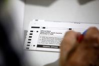 Poll workers prepare absentee ballots for the general election in Raleigh