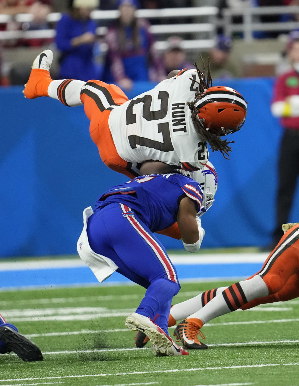 Cleveland Browns running back Kareem Hunt (27) flips over Buffalo Bills cornerback Taron Johnson during the first half of an NFL football game, Sunday, Nov. 20, 2022, in Detroit. (AP Photo/Paul Sancya)