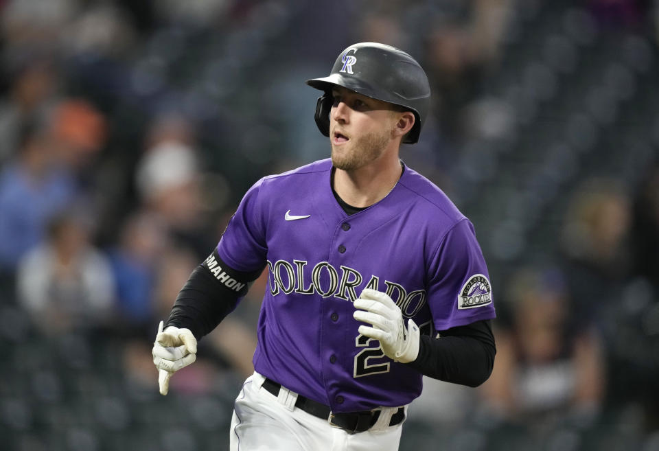 Colorado Rockies' Ryan McMahon gestures toward the dugout as he heads up the first-base line after hitting a solo home run off Arizona Diamondbacks relief pitcher Riley Smith in the fifth inning of a baseball game Friday, May 21, 2021, in Denver. (AP Photo/David Zalubowski)