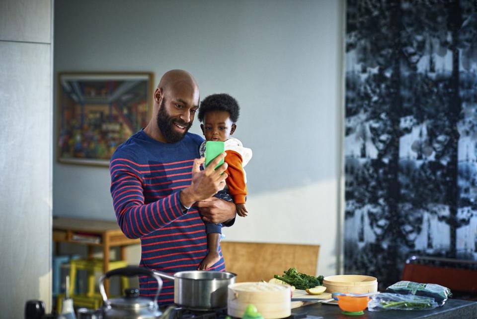 man with baby son 6 11 months at home