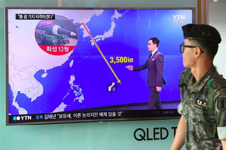 A graphic shows the distance between North Korea and Guam at a railway station in Seoul, South Korea