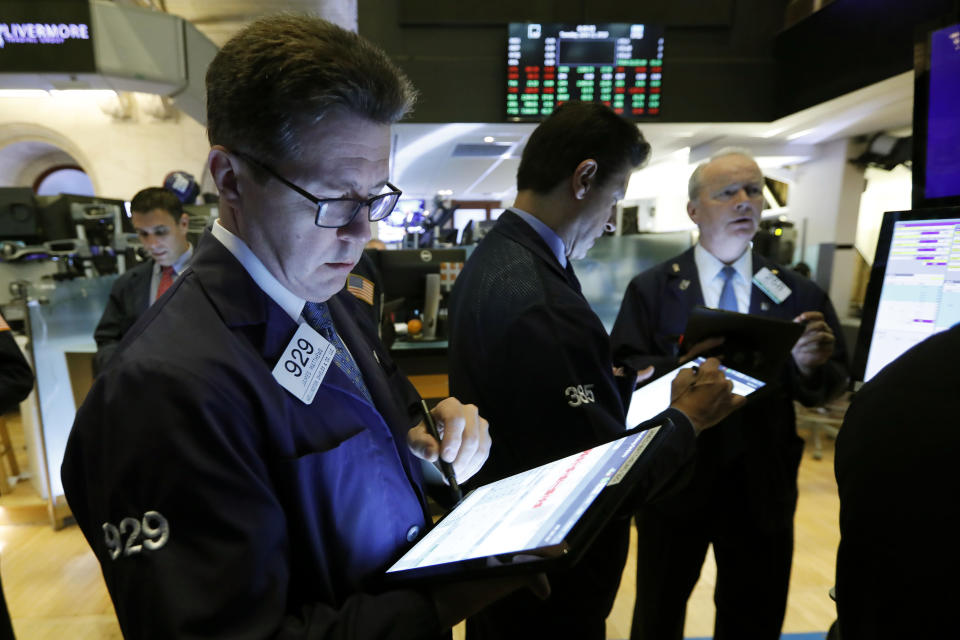 James Matthews, left, works with fellow traders on the floor of the New York Stock Exchange, Tuesday, June 11, 2019. Stocks are rising early Tuesday as Wall Street continues to thrive in June. (AP Photo/Richard Drew)