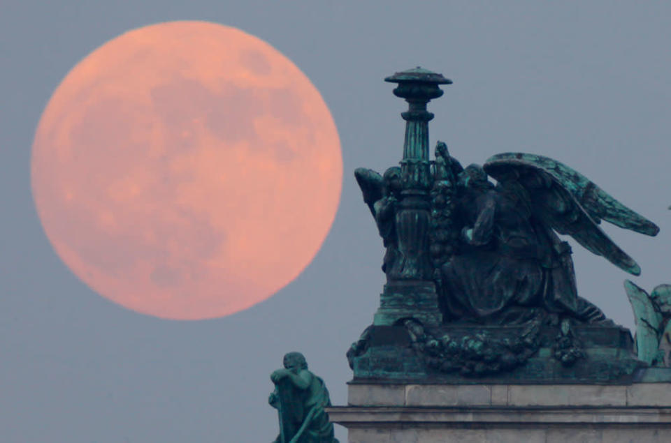 The "supermoon" rises behind statues of angels fixed at the St. Isaak's Cathedral in St.Petersburg, Russia, Saturday, May 5, 2012. Saturday's event is a "supermoon," the closest and therefore the biggest and brightest full moon of the year.