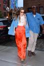 <p>This bold bright shade is shaping up to be one of summer's hottest colors and if you don't believe me, just ask Gigi's pants. Per usual, the model added a bit of retro flare to her fit with a '70s-inspired denim jacket and cat eye sunnies. </p>