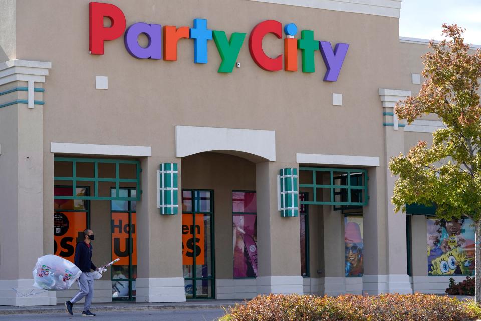 A shopper leaves a Party City store in Vernon Hills, Ill., Thursday, Oct. 15, 2020.  Party City Holdco Inc. has filed for Chapter 11 bankruptcy protection, Wednesday, Jan. 18, 2023 as the party supply chain confronts inflationary pressures and a pullback in consumer spending. The party supplies chain, which operates more than 800 company-owned and franchise stores throughout North America, has been long struggling with increased competition from the likes of Walmart and Target.