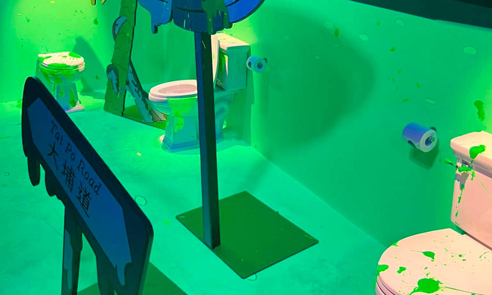 Bathroom at a Hong Kong NFT party, featuring bright lighting and colors on toilets