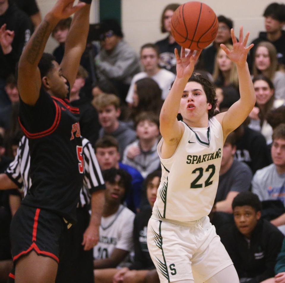 Spackenkill's Dylan Sultzer goes for a three pointer over Port Jervis' Elijah Campbell during the Section 9 Class A boys basketball quarter final on February 26 2024.