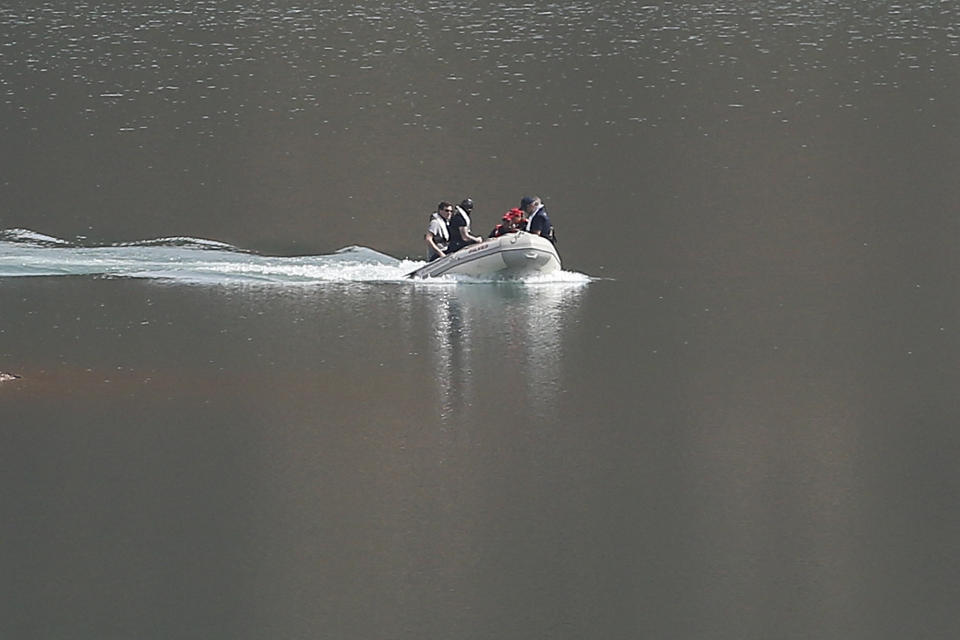 A search dingy navigates in the Arade dam near Silves, Portugal, Tuesday May 23, 2023. Portuguese police aided by German and British officers have resumed their search for Madeleine McCann, the British child who disappeared in the country's southern Algarve region 16 years ago. Some 30 officers could be seen in the area by the Arade dam, about 50 kilometers (30 miles) from Praia da Luz, where the 3-year-old was last seen alive in 2007. (AP Photo/Joao Matos)