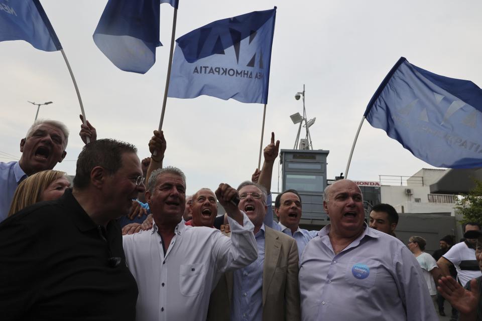 Supporters of the center-right New Democracy shout slogans outside the headquarters of the party in Athens, Greece, Sunday, June 25, 2023. Official projections based on early results from Greece's second election in five weeks indicate the conservative New Democracy party has won by a landslide. (AP Photo/Yorgos Karahalis)