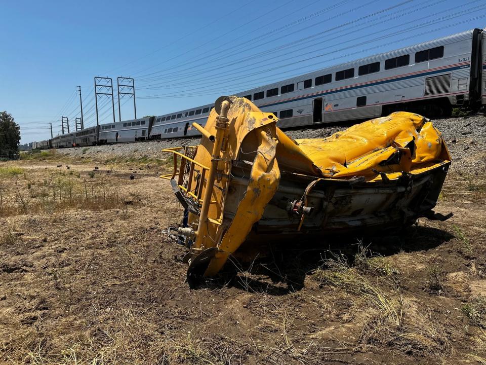 The wrecked tank of a county water truck rests near derailed cars of an Amtrak Coast Starlight train after a collision on tracks in Moorpark late Wednesday morning. The truck driver suffered serious injuries and about 15 train passengers went to local hospitals with minor injuries, officials said.
