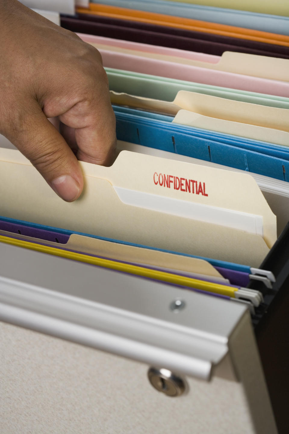 hand holding a confidential folder