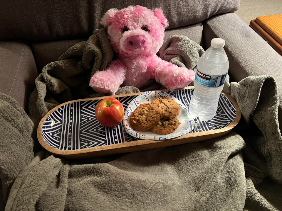 Piggy enjoys snacks from Paula Straus while waiting for her owner to claim her.