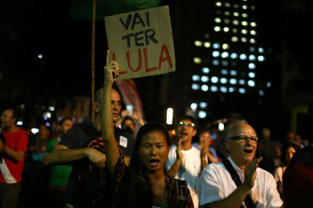 Supporters of former Brazilian President Luiz Inacio Lula da Silva protest against sentencing him to serve a 12-year prison sentence for corruption, in Rio de Janeiro, Brazil April 6, 2018. The sign reads: "It will have Lula." REUTERS/Pilar Olivares