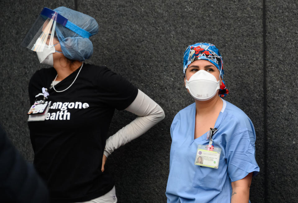 NEW YORK, NY - APRIL 04: Medical personnel are seen outside NYU Langone Health hospital as people applaud to show their gratitude to medical staff and essential workers working on the front lines of the coronavirus pandemic as the country works to stop the spread of COVID-19 on April 4, 2020 in New York City. The coronavirus (COVID-19) pandemic has spread to at least 180 countries and territories across the world, claiming over 60,000 lives and infecting hundreds of thousands more. (Photo by Noam Galai/Getty Images)