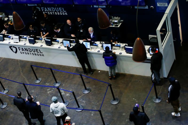 People make their bets at the FANDUEL sportsbook during the Super Bowl LIII in East Rutherford, New Jersey