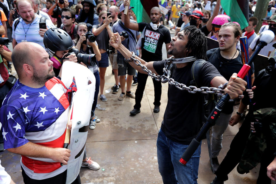 <p>White nationalists, neo-Nazis and members of the “alt-right” leap over barricades inside Lee Park during the “Unite the Right” rally Aug. 12, 2017 in Charlottesville, Va. (Photo: Chip Somodevilla/Getty Images) </p>