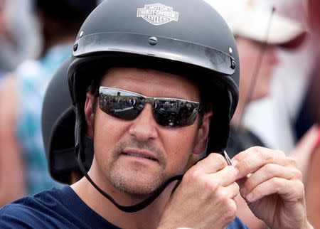 Todd Palin, husband of Sarah Palin, former governor of Alaska, adjusts his helmet before taking part in the Rolling Thunder motorcycle ride to honour U.S. veterans in Washington, in this file photo taken May 29, 2011. REUTERS/Joshua Roberts/Files