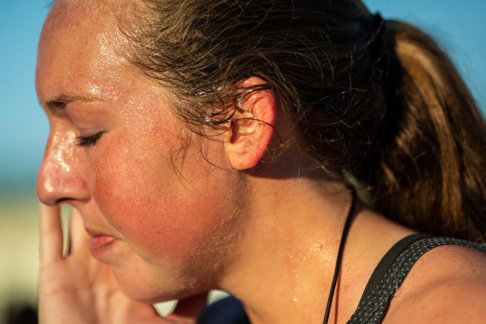 Molly Lear wipes away sweat after finishing the 40th Annual Turkey Trot 5K race on Thursday, November 28, 2019, in Cape Coral.
