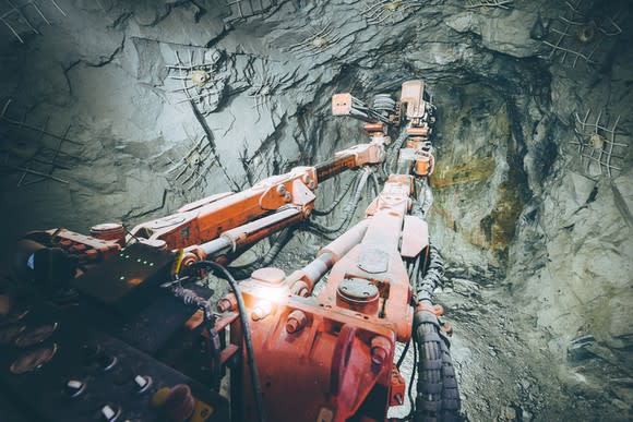 An underground mining vehicle facing a rock wall.