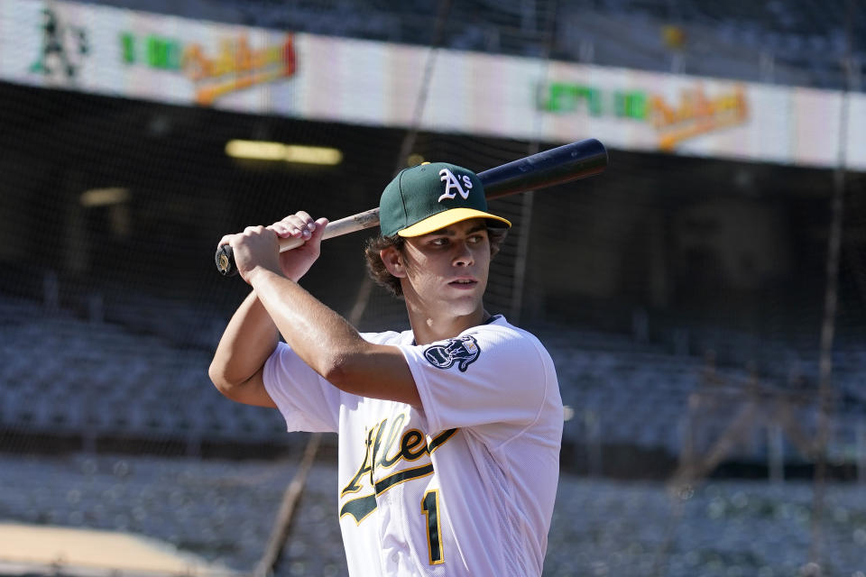 Oakland Athletics draft pick Max Muncy poses for photos before a baseball game between the Athletics and the Los Angeles Angels in Oakland, Calif., Monday, July 19, 2021. (AP Photo/Jeff Chiu)