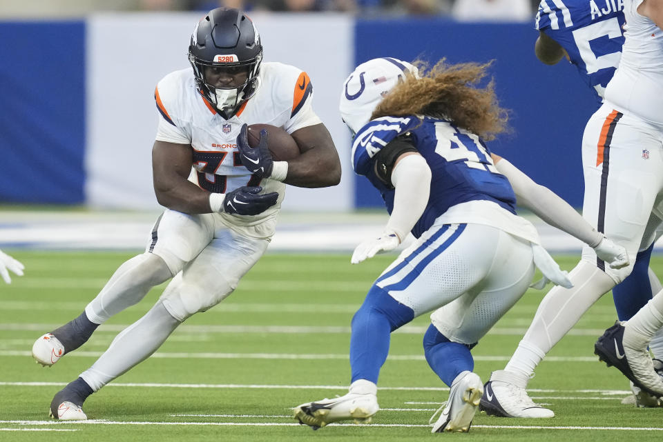 Denver Broncos running back Audric Estime (37) carries the ball against Indianapolis Colts linebacker Grant Stuard (41) during the third quarter of a preseason NFL football game, Sunday, Aug. 11, 2024, in Westfield, Ind. (AP Photo/Darron Cummings)