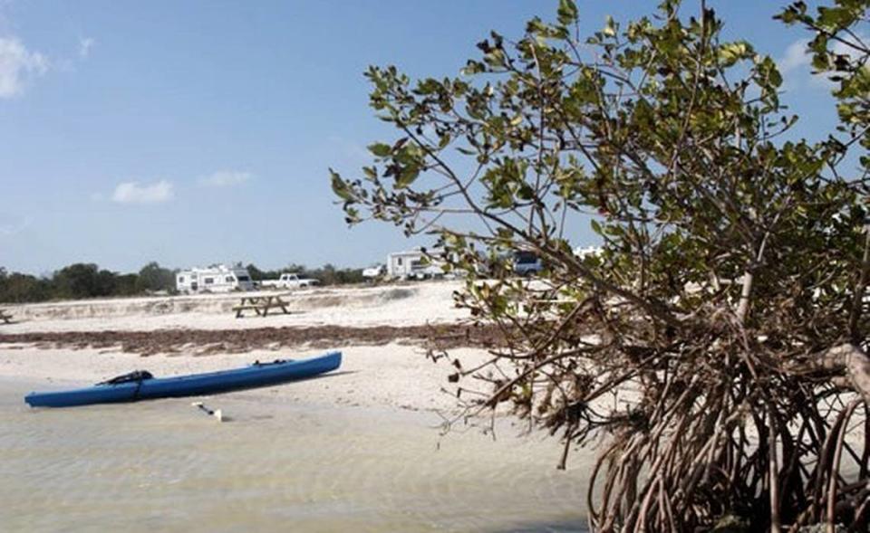 A kayak awaits a rider on the beach at Curry Hammock State Park.