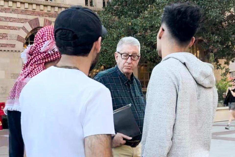 John Strauss pauses to talk to students at USC.