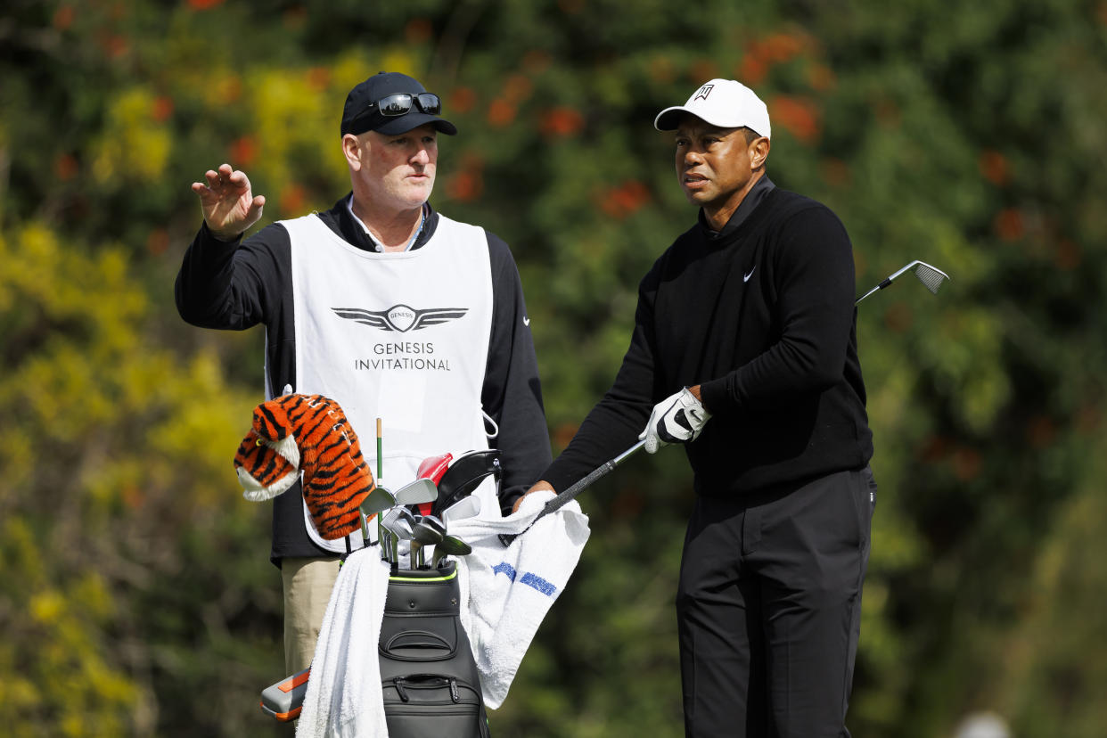 Joe LaCava (left) continues to look for opportunities with Tiger Woods (right) out indefinitely. (AP Photo/Ryan Kang)