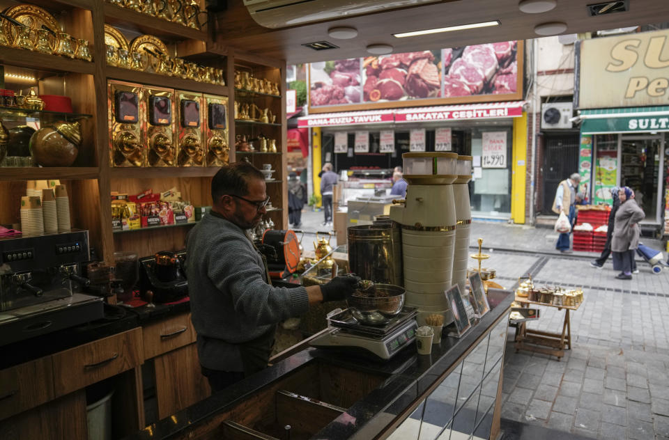 Syrian Muhammed Al Zakret, 57, works in a hot drinks and coffee shop in an open public market in the Fatih district of Istanbul, Tuesday, April 29, 2023. Syrians fleeing their country's civil war were once welcomed in Turkey out of compassion, making the country home to the world’s largest refugee community. But as their numbers grew — and as Turkey began to grapple with a battered economy, including skyrocketing food and housing prices — so did calls for their return, with the repatriation of Syrians and other migrants has become a top theme in presidential and parliamentary elections on Sunday, May 14. (AP Photo/Khalil Hamra)