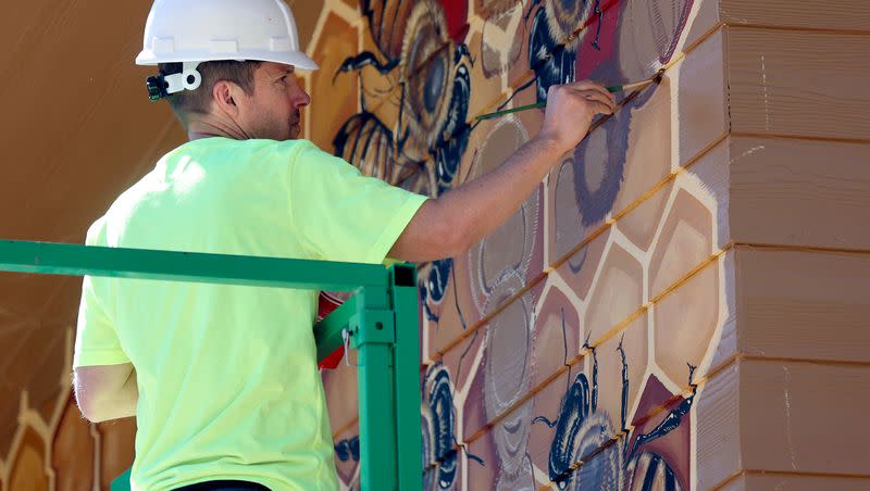 Matt Willey, artist and founder of The Good of the Hive initiative, paints a bee and pollinator mural on the new Norma W. Matheson Education Animal Center inside the future Aline W. Skaggs Wild Utah exhibit at the Hogle Zoo in Salt Lake City on Tuesday, Sept. 26, 2023.