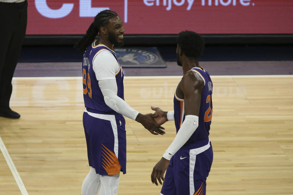 Phoenix Suns' Jae Crowder (99) smiles at teammate Phoenix Suns' Deandre Ayton (22) in the second half of an NBA basketball game against the Minnesota Timberwolves, Sunday, Feb. 28, 2021, in Minneapolis. (AP Photo/Stacy Bengs)