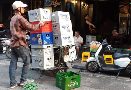 A man unloads beer outside a restaurant in the Old Quarter in Hanoi