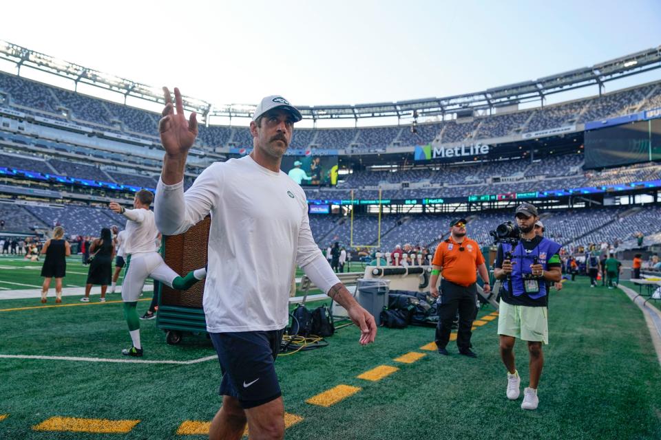 New York Jets quarterback Aaron Rodgers waves to fans during warm-ups before a preseason NFL football game against the Tampa Bay Buccaneers, Saturday, Aug. 19, 2023, in East Rutherford, N.J.