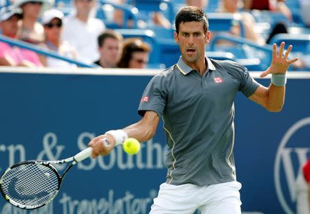 Aug 19, 2015; Cincinnati, OH, USA; Novak Djokovic (SRB) returns a shot against Benoit Paire (not pictured) on day five during the Western and Southern Open tennis tournament at Linder Family Tennis Center. Mandatory Credit: Aaron Doster-USA TODAY Sports