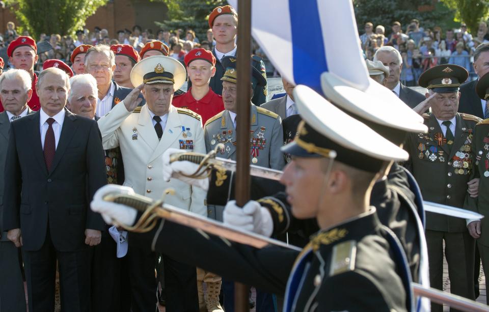 Russian President Vladimir Putin, left, and Russian WWII veterans, first row, attend a laying ceremony in Kursk, 426 kilometers (266 miles) south of Moscow, Russia, Thursday, Aug. 23, 2018. Putin attended a ceremony marking the 75th anniversary of the battle of Kursk in which the Soviet army routed Nazi troops. It is described by historians as the largest tank battle in history involving thousands of tanks. (AP Photo/Alexander Zemlianichenko, Pool)