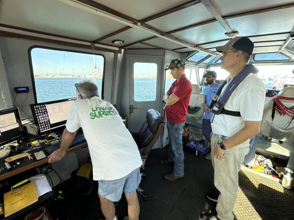Port Canaveral officials and representatives of a survey company work on measuring Port Canaveral channel depths after Hurricane Ian cleared the area. That is a key component of reopening the port after a hurricane. Second from left is Port Canaveral Senior Harbormaster Cody Driggers. At right is Bob Musser, the port's senior environmental director.
