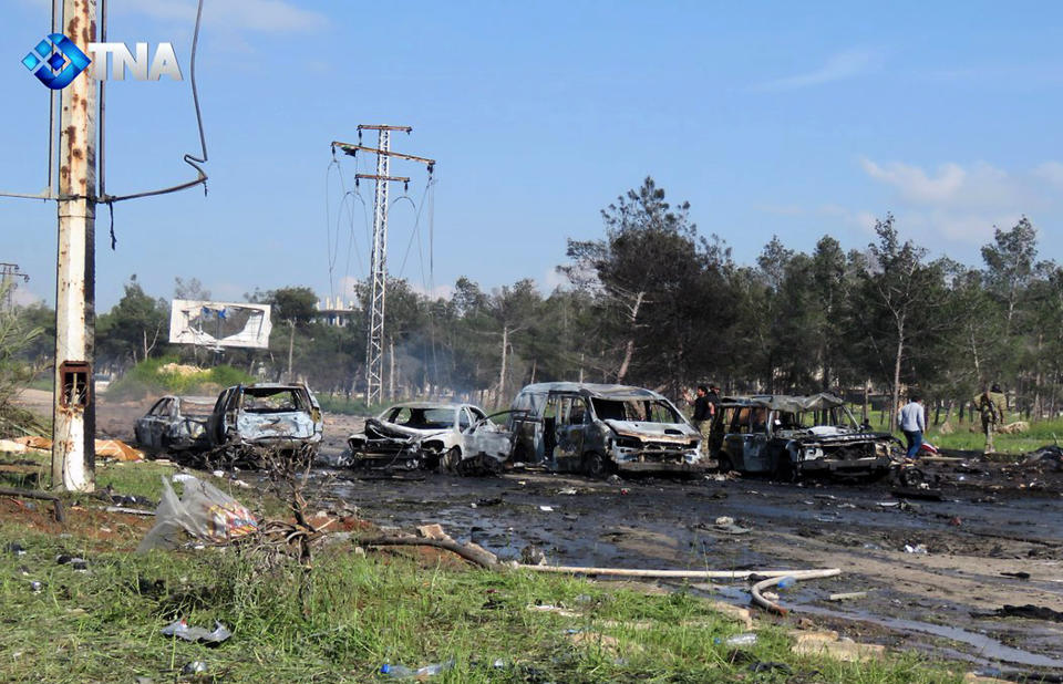 This image released by the Thiqa News Agency, shows charred and damaged cars at the scene of an explosion in the Rashideen area, a rebel-controlled district outside Aleppo city, Syria, Saturday, April. 15, 2017. Syrian TV said at least 39 people were killed Saturday in an explosion that hit near buses carrying evacuees from two towns besieged by rebels nearby. (Thiqa News via AP)