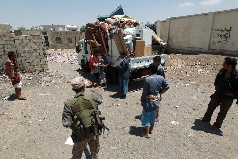 Yemenis pack their belongings into the back of a truck in Sanaa as they flee the capital as Saudi-led coalition warplanes continue to strike Shiite Huthi militia bases on March 31, 2015