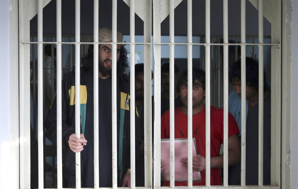 FILE - In this Dec. 14, 2019 file photo, jailed Taliban are seen inside the Pul-e-Charkhi jail in Kabul, Afghanistan. A three-member Taliban technical team arrived Tuesday, March 31, 2020, in the Afghan capital to oversee the release of their prisoners as part of a peace deal signed by the Taliban and the U.S., a spokesman for the insurgent group said. (AP Photo/Rahmat Gul, File)