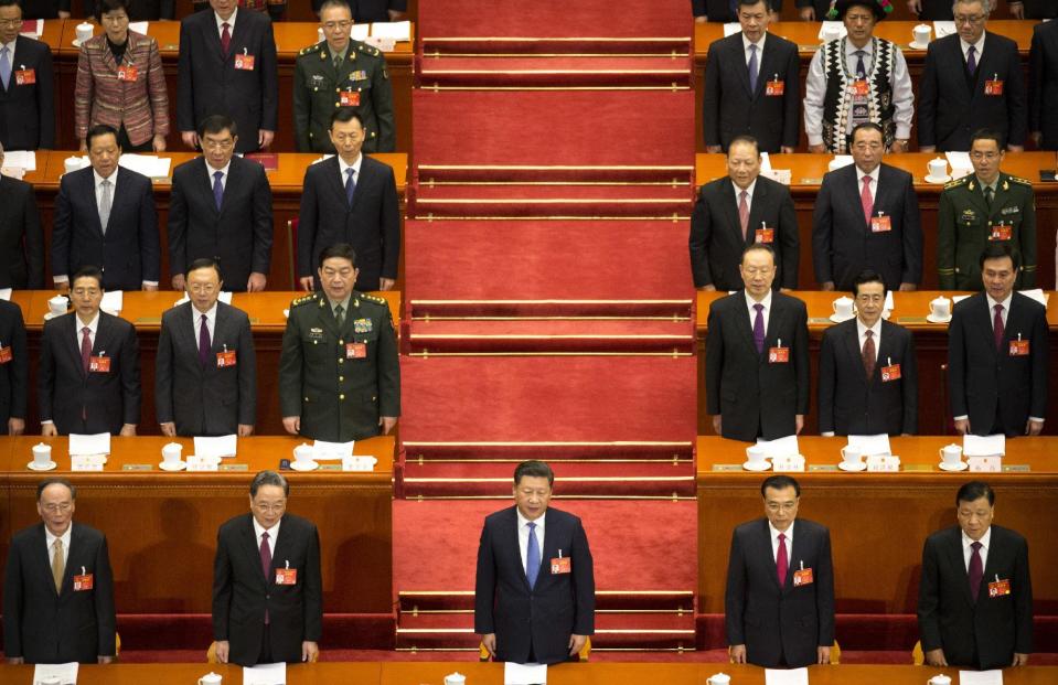 From front left, Wang Qishan, Yu Zhengsheng, Chinese President Xi Jinping, Premier Li Keqiang, and Liu Yunshan stand during the start of the opening session of China's annual National People's Congress in Beijing's Great Hall of the People, Sunday, March 5, 2017. China's top leadership as well as thousands of delegates from around the country are gathered at the Chinese capital for the annual legislature meetings. (AP Photo/Mark Schiefelbein)