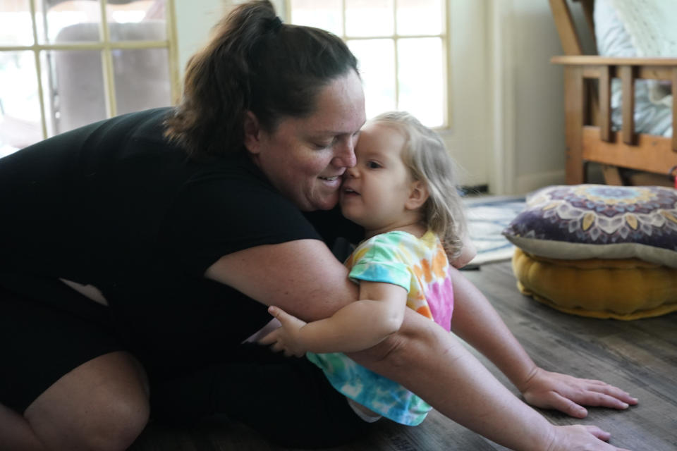 Carolanne sits with her mother, Justine Hanusch during a prenatal support group meeting at The Farm Midwifery Center, Thursday, Aug. 31, 2023, in Summertown, Tenn. (AP Photo/George Walker IV)