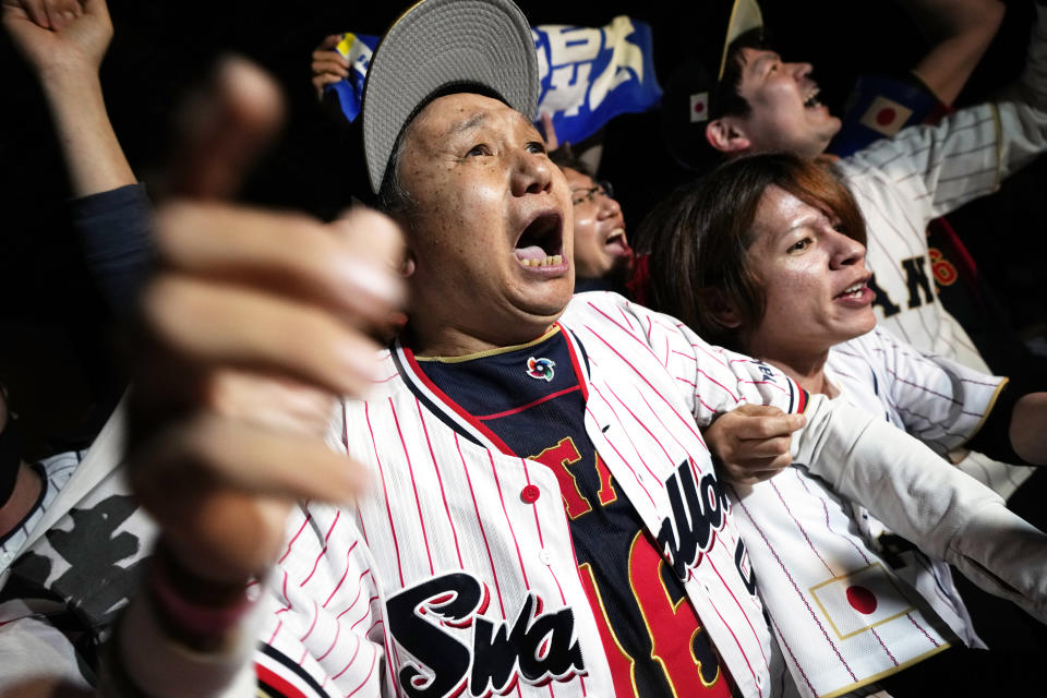 People celebrate Japan's victory against United States as they watch on a live stream of a World Baseball Classic (WBC) final being played at LoanDepot Park in Miami, during a public viewing event Wednesday, March 22, 2023, in Tokyo. (AP Photo/Eugene Hoshiko)