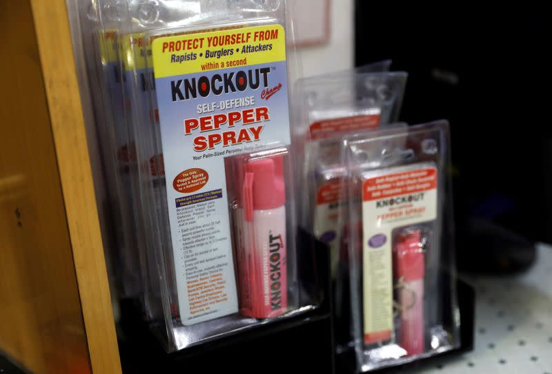 Bottles of pepper spray are displayed for sale inside a shop in New Delhi