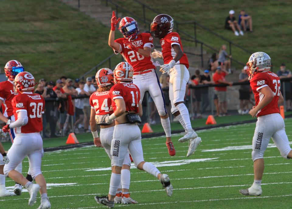 Licking Heights' D'Angelo Goodrich, right, celebrates his interception with Licking Valley's Jacob Wheeler on Friday.