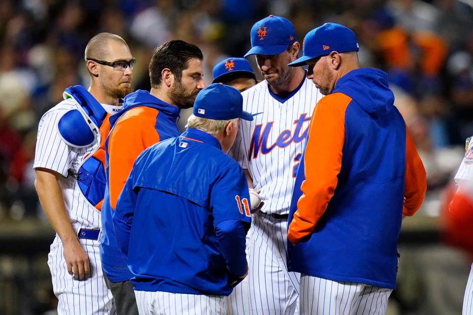 New York Mets starting pitcher Max Scherzer hands the ball to manager Buck Showalter during the sixth inning of the team's baseball game against the St. Louis Cardinals on Wednesday, May 18, 2022, in New York. (AP Photo/Frank Franklin II)