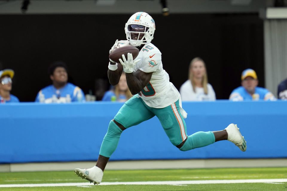 FILE - Miami Dolphins wide receiver Tyreek Hill catches a touchdown during the second half of an NFL football game against the Los Angeles Chargers Sunday, Sept. 10, 2023, in Inglewood, Calif. Tyreek Hill is a finalist for The Associated Press 2023 Offensive Player of the Year.(AP Photo/Ashley Landis, File)